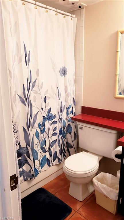 170 Turtle Lake Court, Unit 101 Naples, FL 34105 - Photo 10 of 16 a white toilet sitting next to a shower curtain