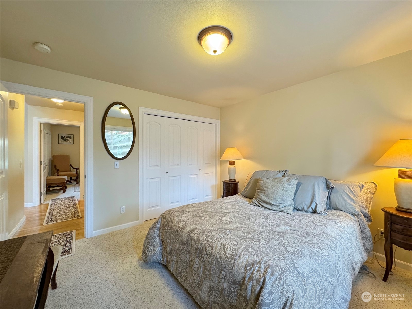 359 Dungeness Meadows Sequim, WA 98382 - Photo 23 of 37 a bedroom with a large bed and a chandelier