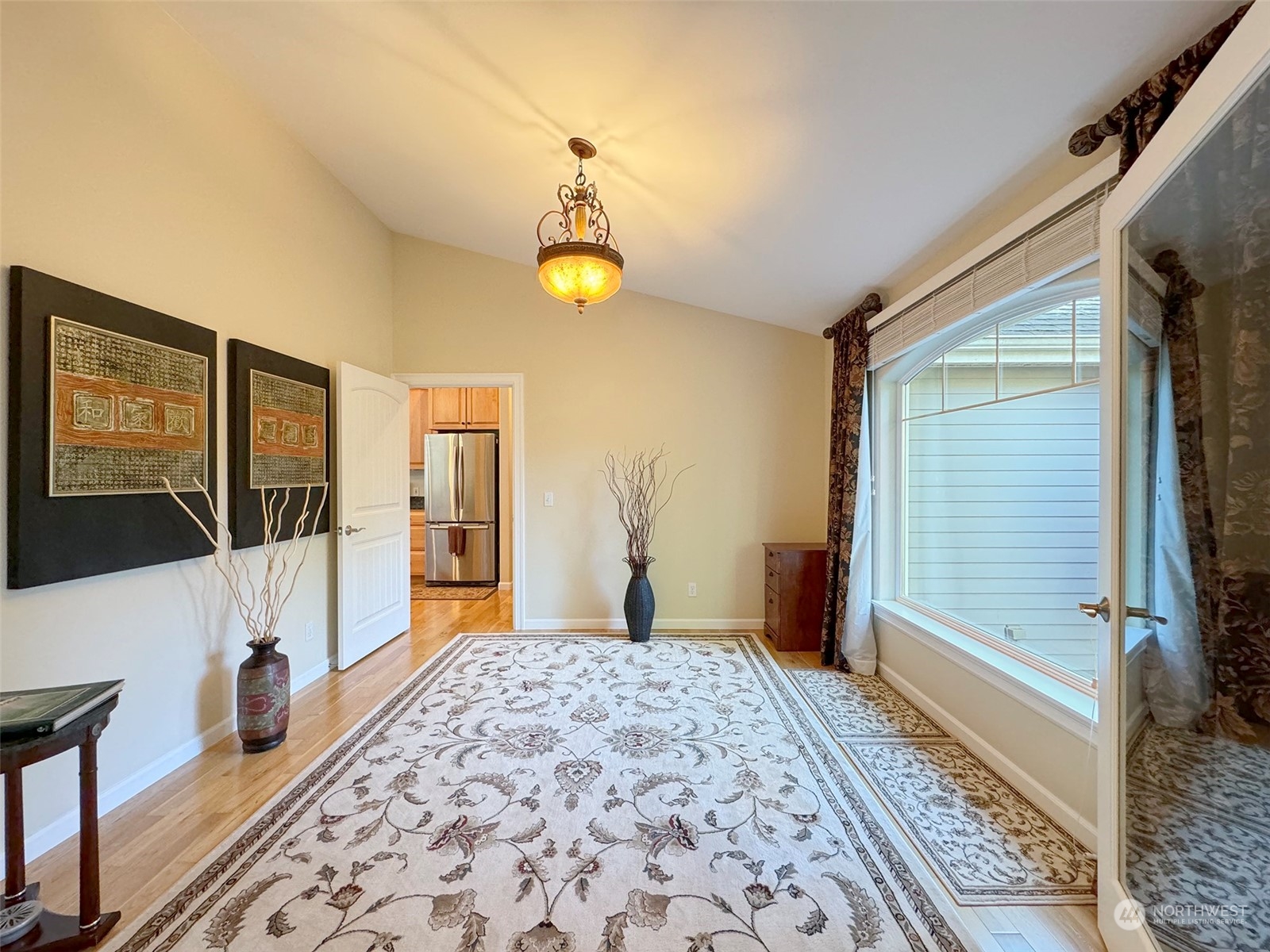 359 Dungeness Meadows Sequim, WA 98382 - Photo 24 of 37 a bedroom with a bed and a chandelier