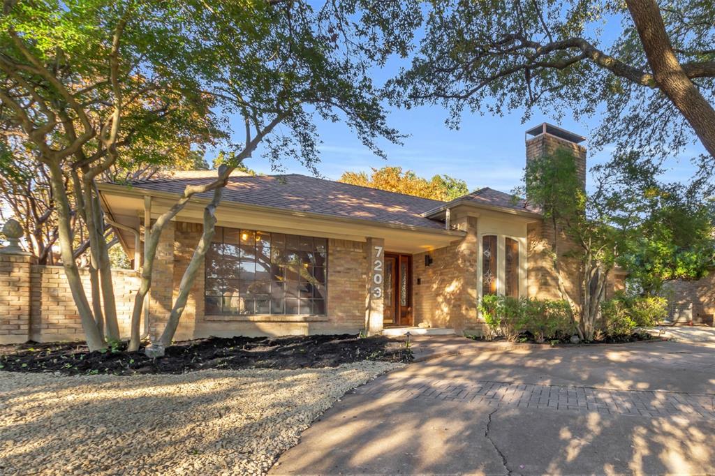 View of front of property featuring a chimney and roof with shingles