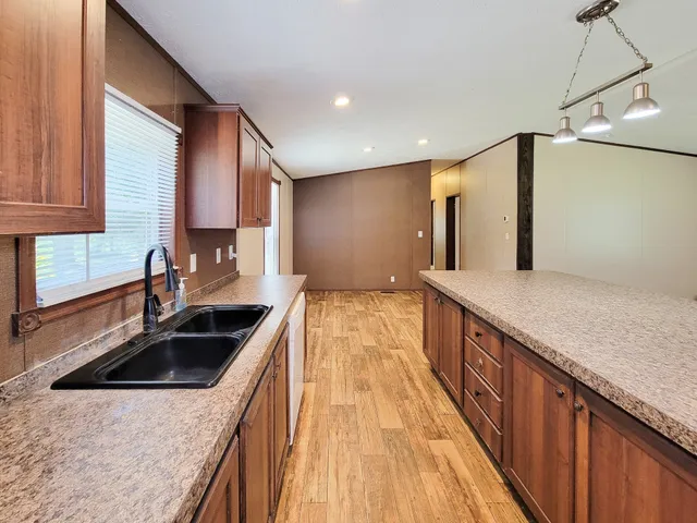 a kitchen with stainless steel appliances granite countertop a sink and a stove