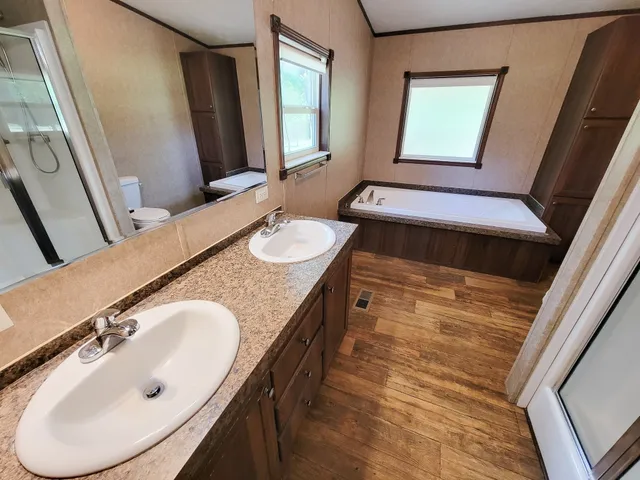 a bathroom with a double vanity sink and a mirror