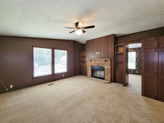 a view of empty room with fireplace