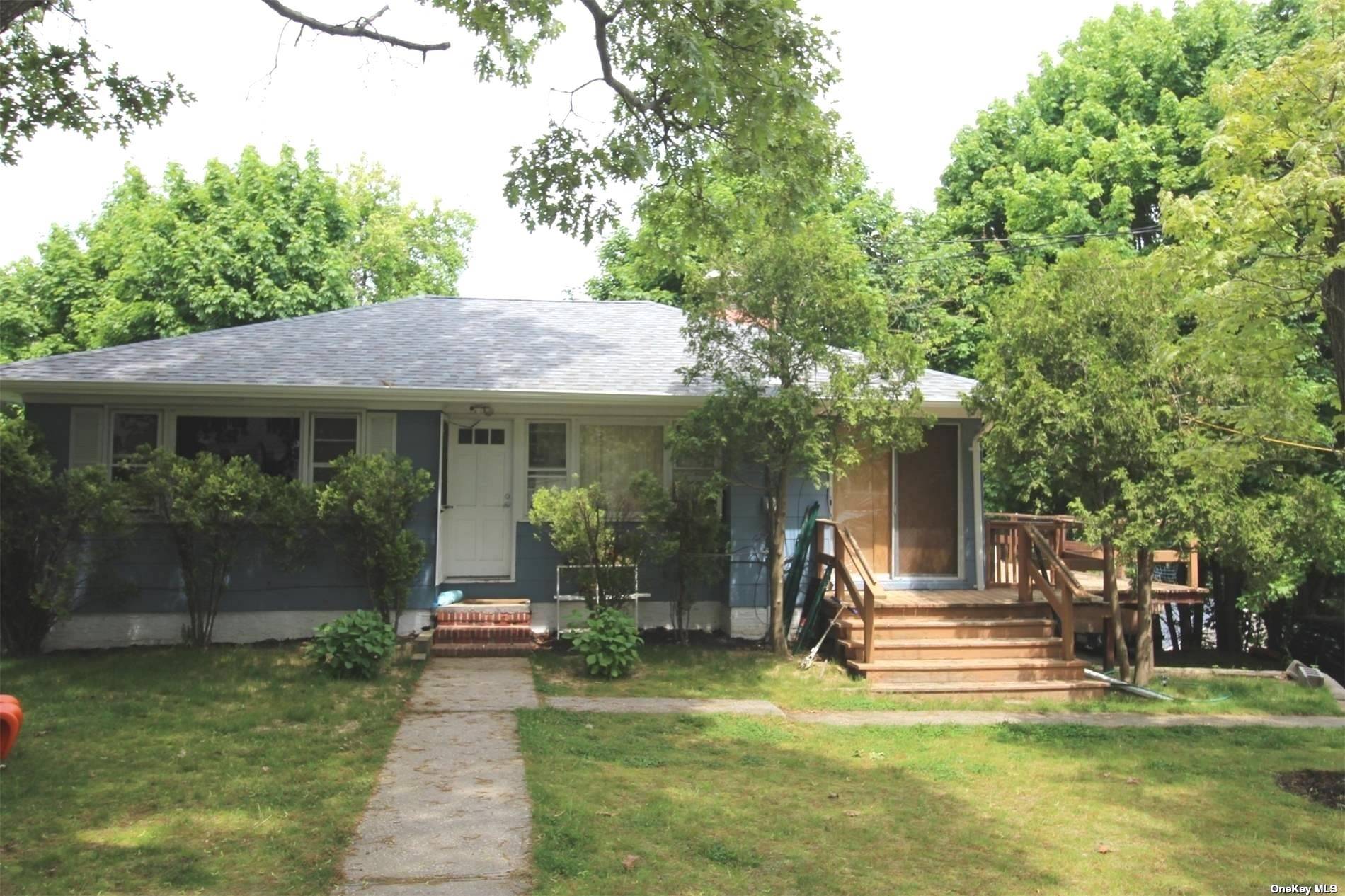 a front view of a house with a yard table and chairs