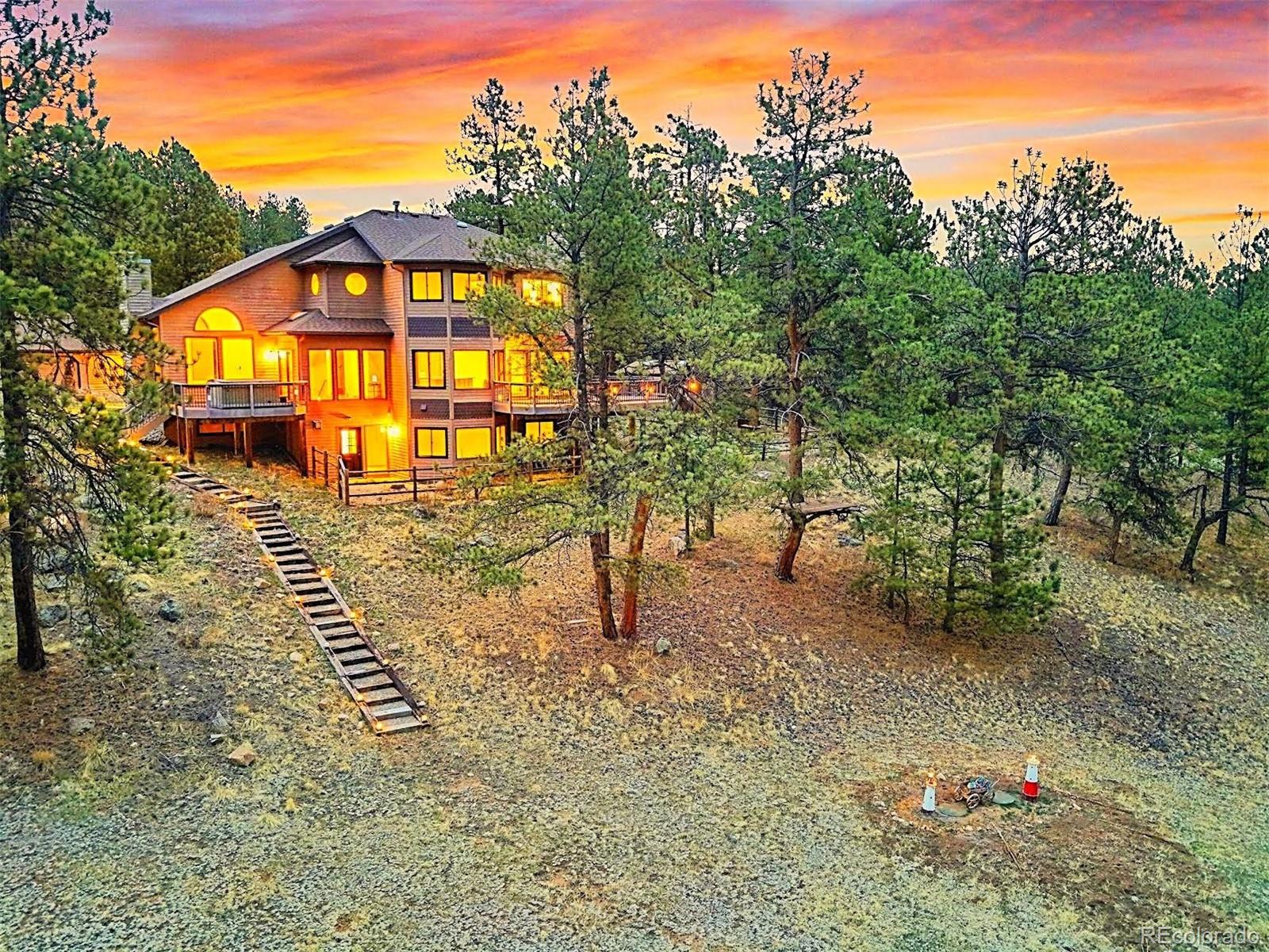 13342 Douglass Ranch Drive Pine, CO 80470 - Photo 2 of 31 a view of a large yard with potted plants