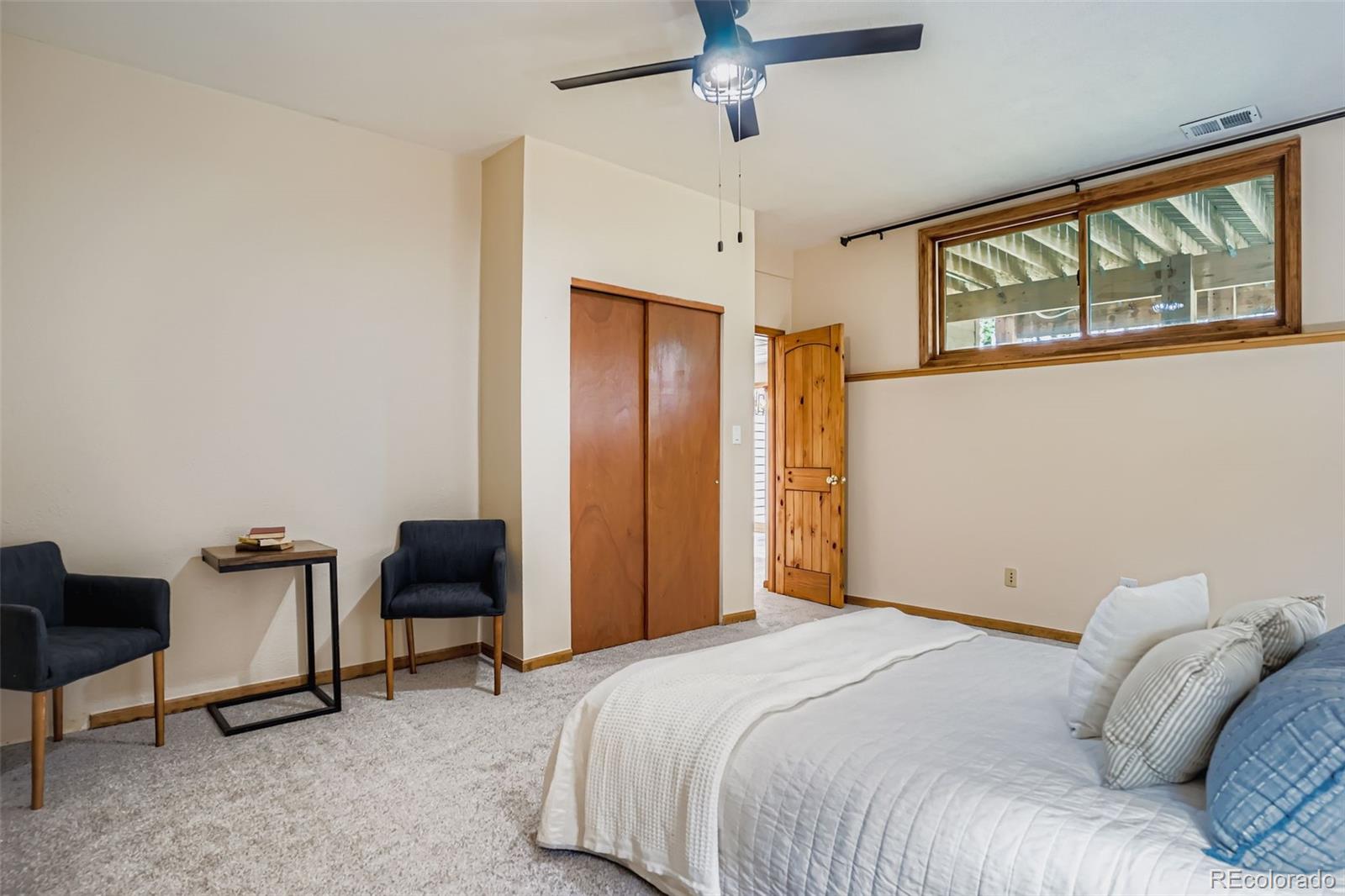 13342 Douglass Ranch Drive Pine, CO 80470 - Photo 23 of 31 a bedroom with a large bed and a desk