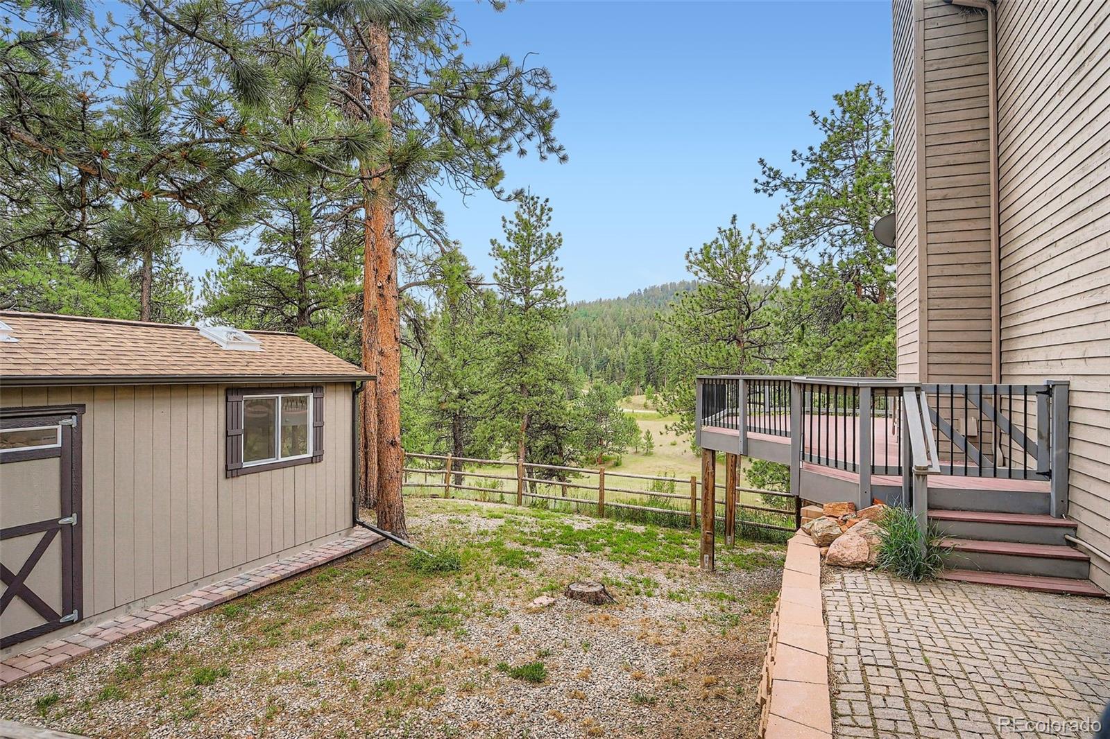 13342 Douglass Ranch Drive Pine, CO 80470 - Photo 28 of 31 a view of backyard with deck and seating area