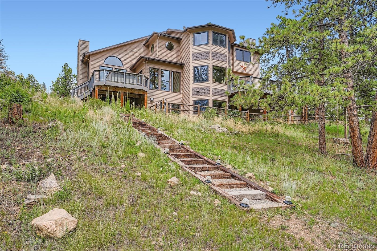 13342 Douglass Ranch Drive Pine, CO 80470 - Photo 29 of 31 a aerial view of a house with a yard and potted plants
