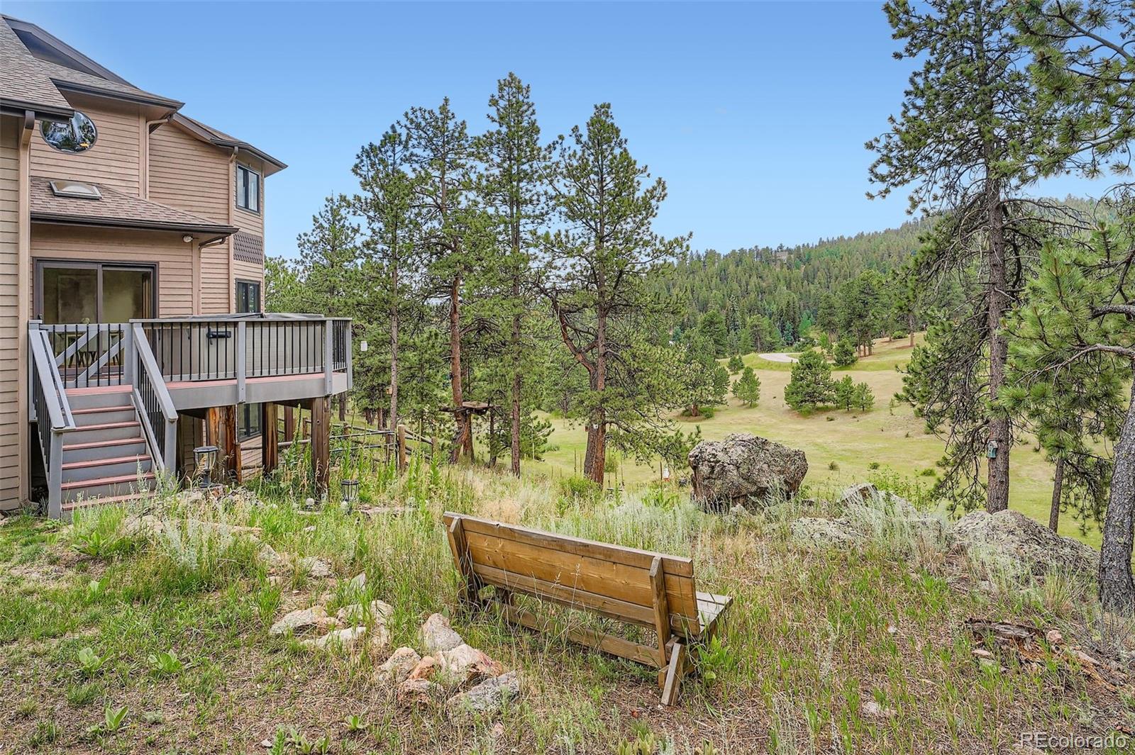 13342 Douglass Ranch Drive Pine, CO 80470 - Photo 31 of 31 a view of a chairs in a backyard