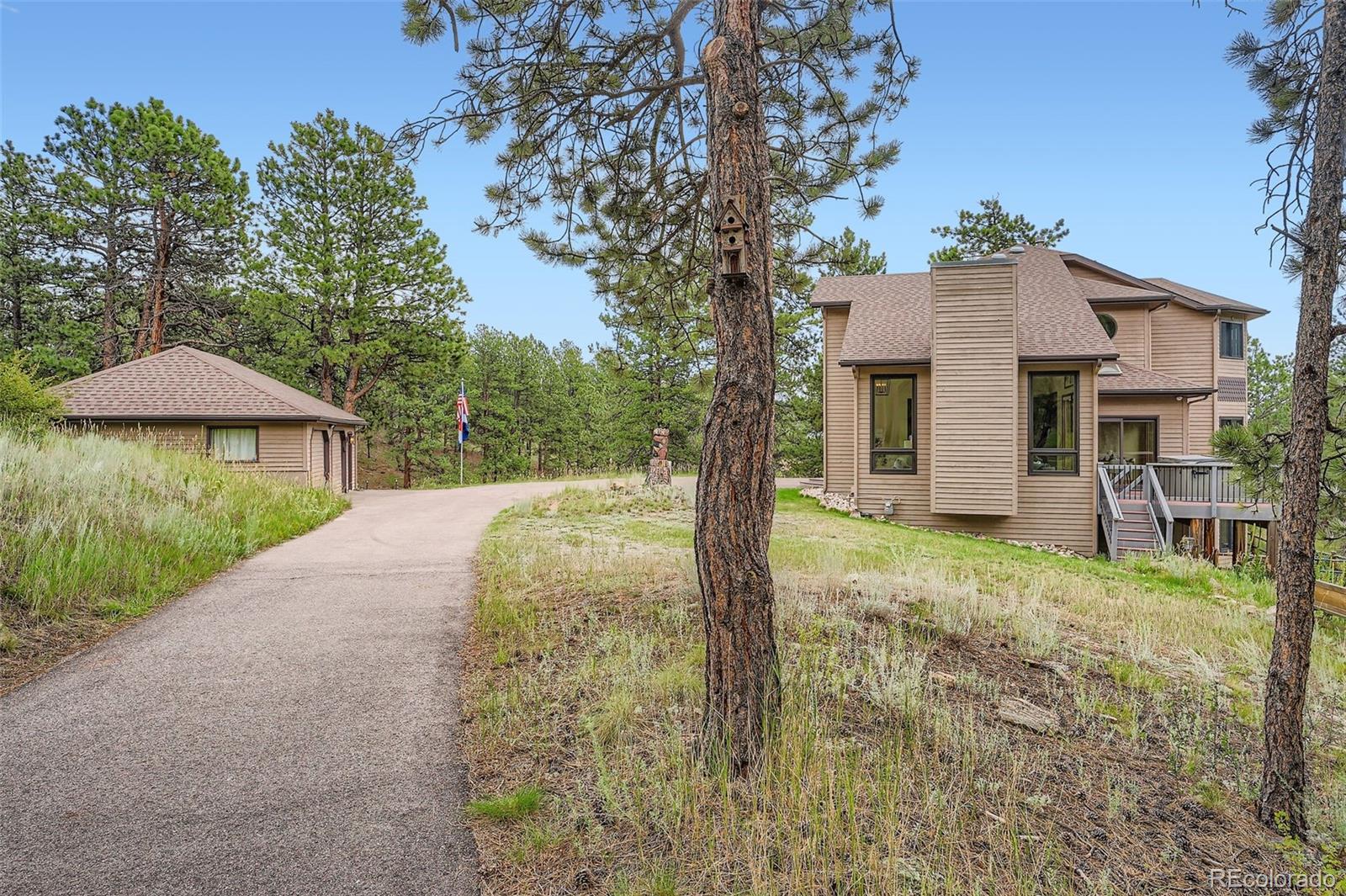 13342 Douglass Ranch Drive Pine, CO 80470 - Photo 4 of 31 a view of a house with backyard and garden