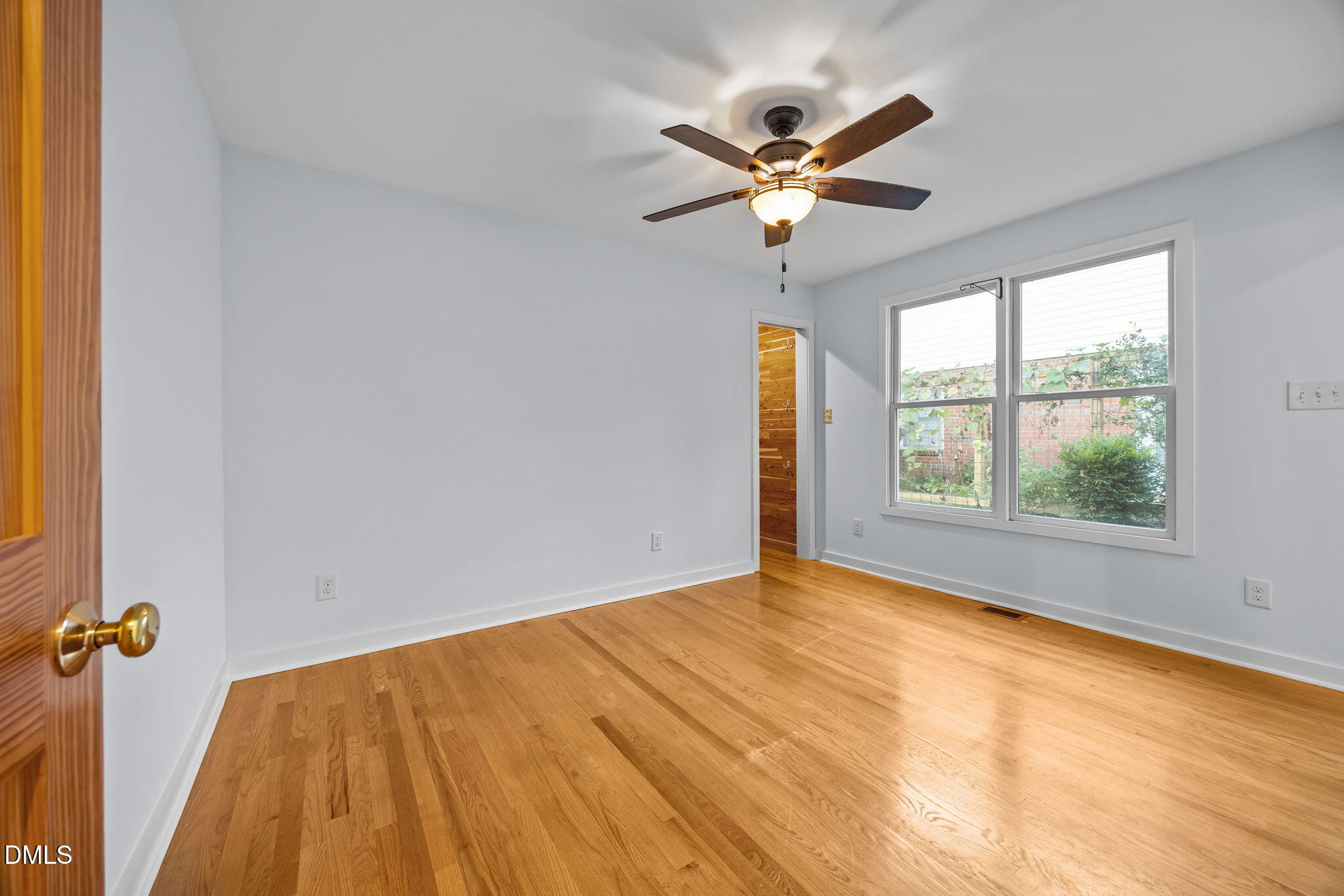 2231 Rumson Road Raleigh, NC 27610 - Photo 18 of 45 a view of empty room with wooden floor and fan