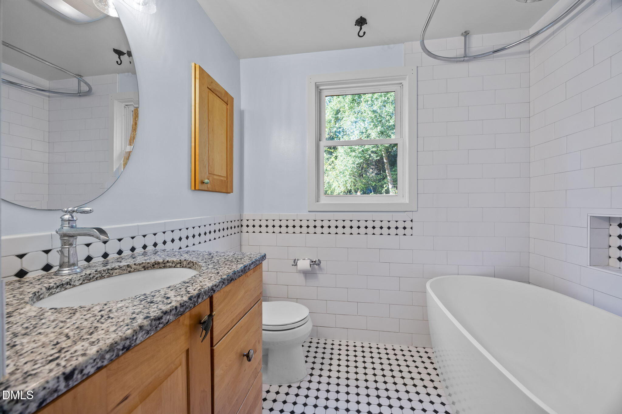 2231 Rumson Road Raleigh, NC 27610 - Photo 23 of 45 a bathroom with a granite countertop sink a toilet a mirror a bathtub and shower