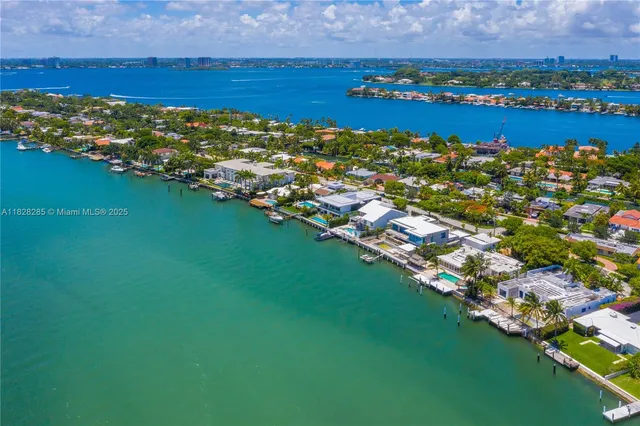 a view of a city with lots of residential buildings ocean and mountain view in back