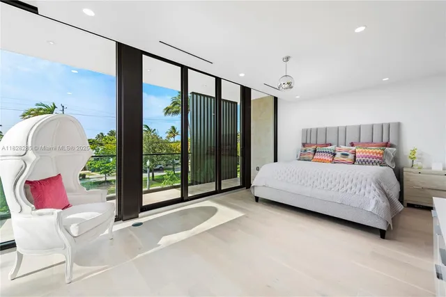 a bedroom with a bed and large window