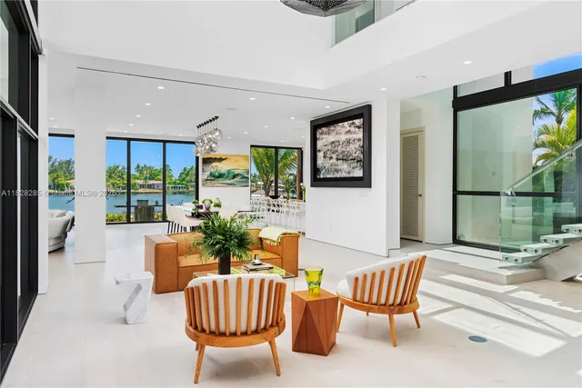 a view of a livingroom with furniture and a floor to ceiling window