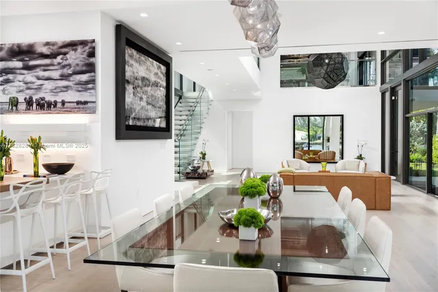 a living room with furniture and a floor to ceiling window