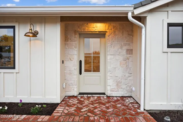 a view of a door and a window of the house