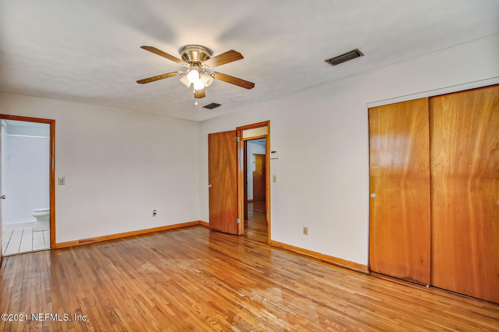 8290 Barracuda Road Jacksonville, FL 32244 - Photo 26 of 41 a view of an empty room with window and wooden floor