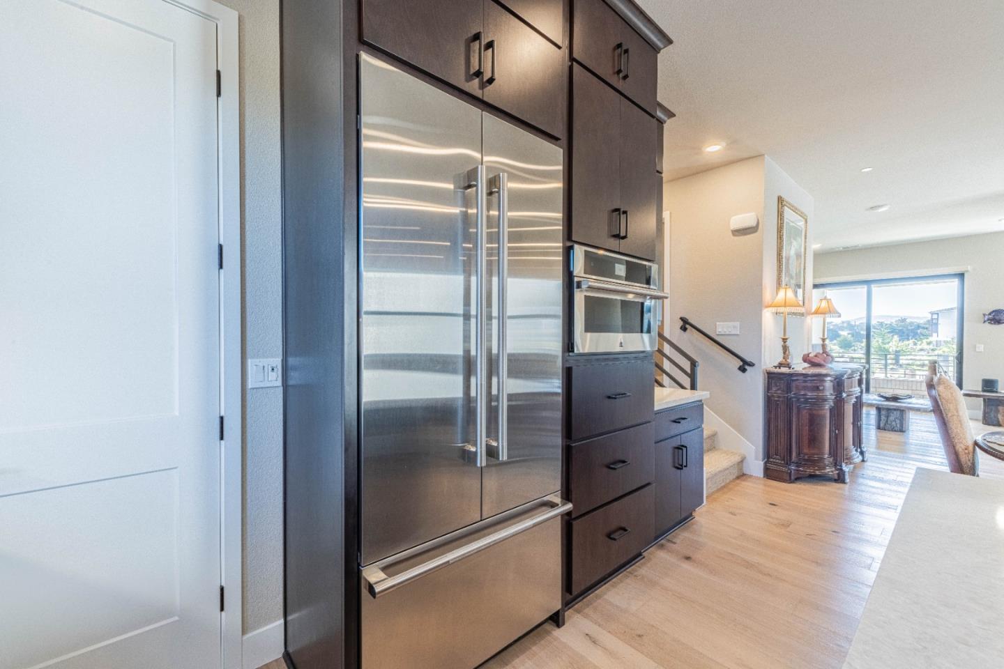135 8th Street Marina, CA 93933 - Photo 36 of 69 a kitchen with stainless steel appliances kitchen island granite countertop a refrigerator and cabinets