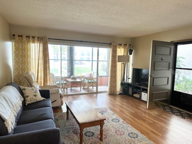 7701 Starkey Road, Unit 731 Seminole, FL 33777 - Photo 6 of 19 a living room with furniture large window and a flat screen tv