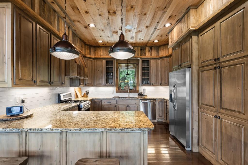 436 Geronimo Road Cherry Log, GA 30522 - Photo 12 of 58 a kitchen with stainless steel appliances granite countertop a sink refrigerator and cabinets