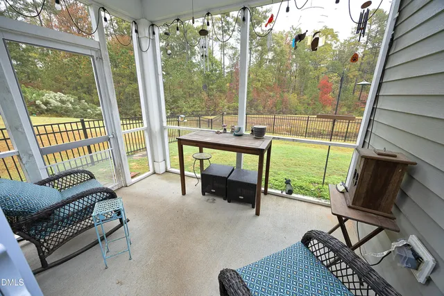a living room with furniture and a floor to ceiling window