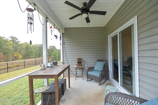 a view of a porch with furniture and a yard