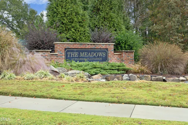 a front view of a brick house with large windows