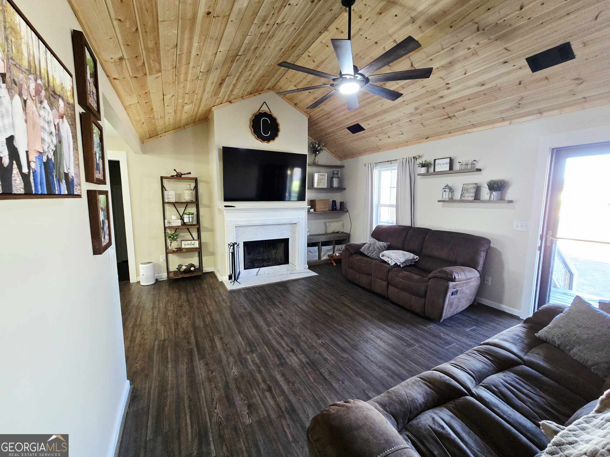 10 Shannons Lane Comer, GA 30629 - Photo 22 of 50 a living room with furniture a fireplace and a flat screen tv