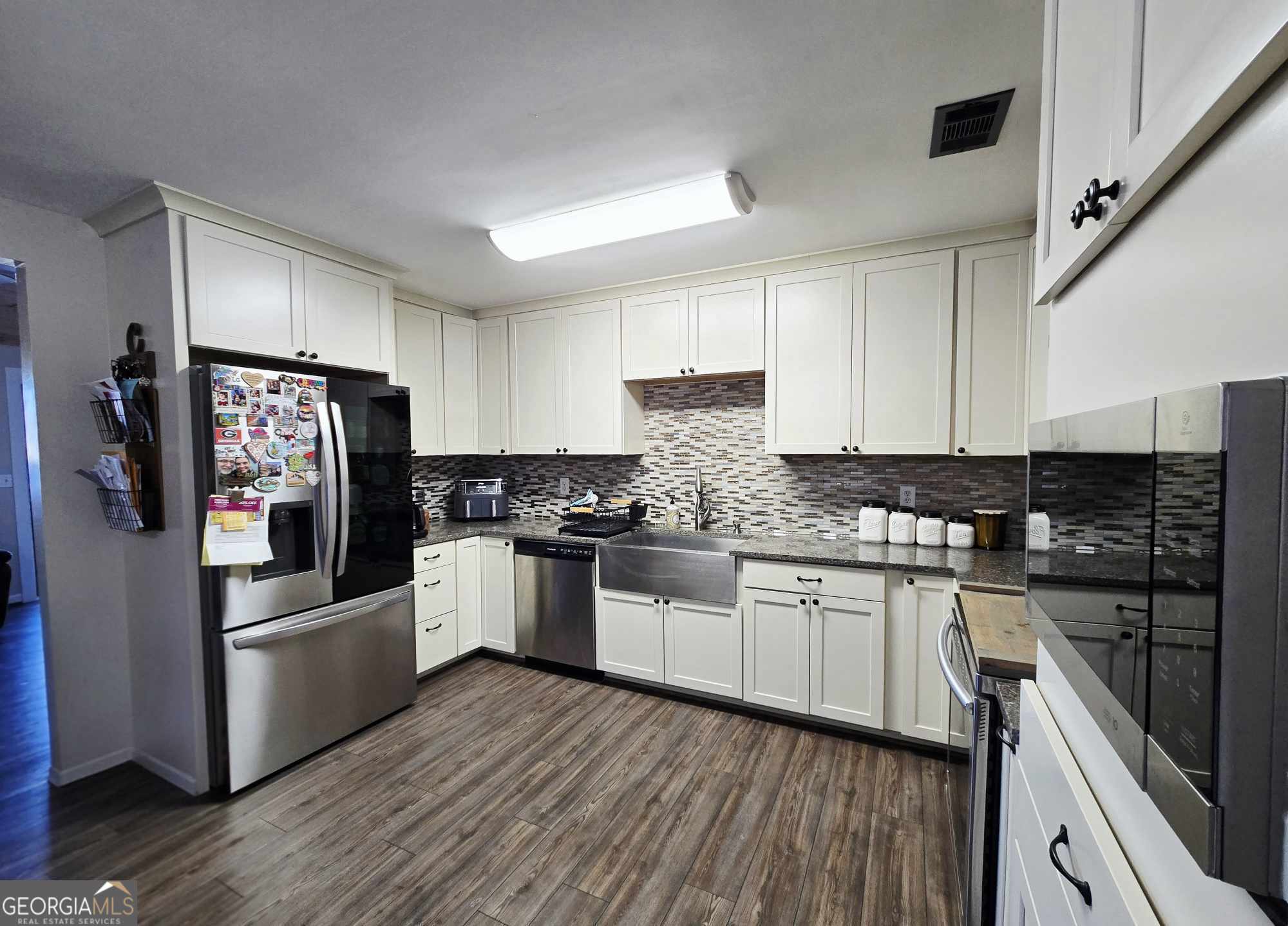 10 Shannons Lane Comer, GA 30629 - Photo 27 of 50 a kitchen with granite countertop a refrigerator stove top oven and sink