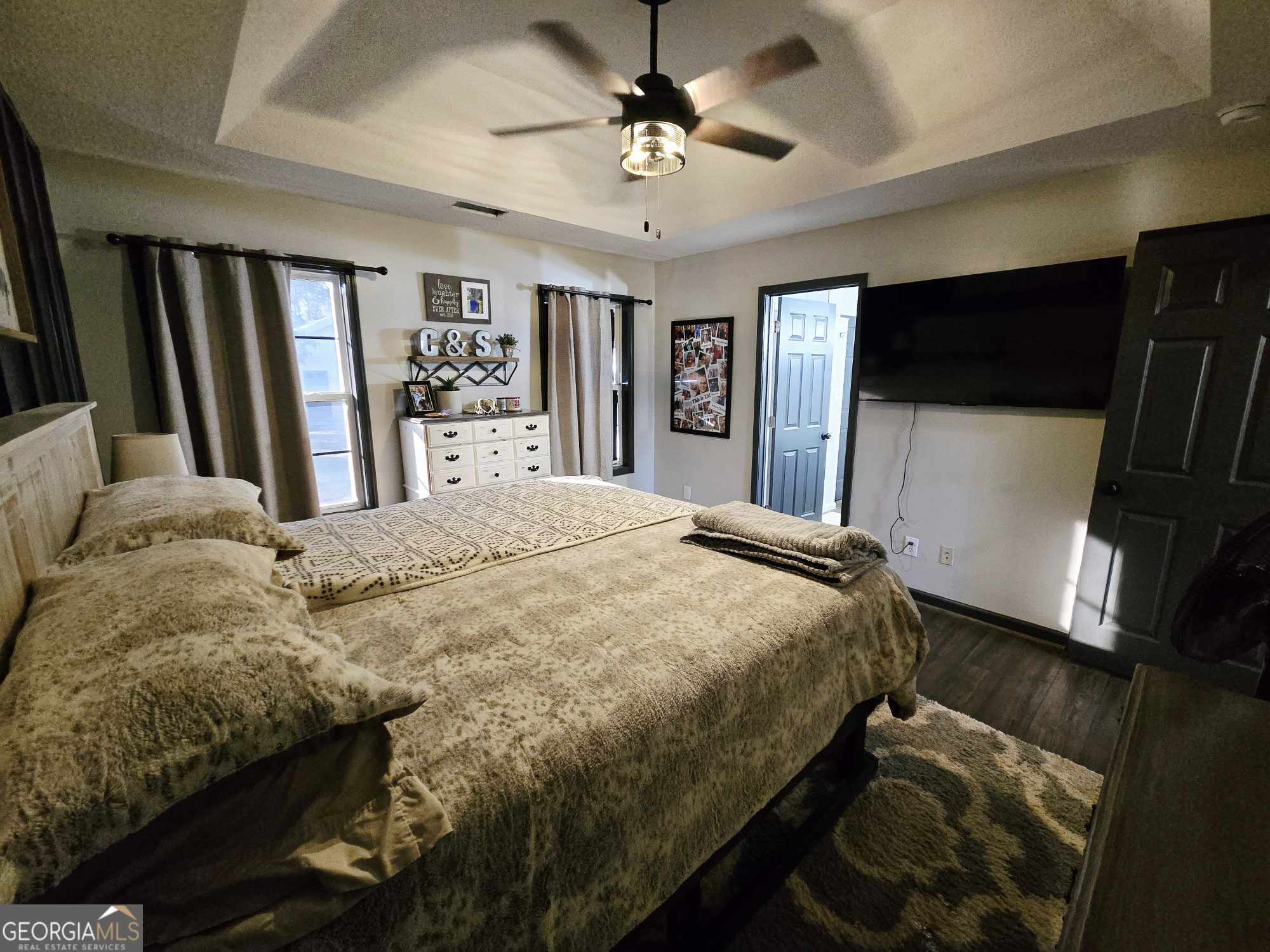 10 Shannons Lane Comer, GA 30629 - Photo 37 of 50 a bedroom with a bed a mirror and a flat screen tv
