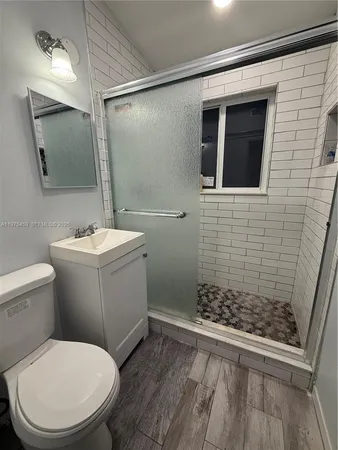 a bathroom with a toilet sink and shower
