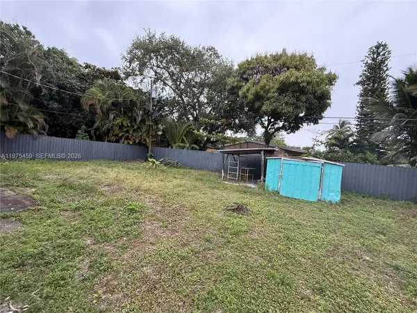 a view of a backyard with trees