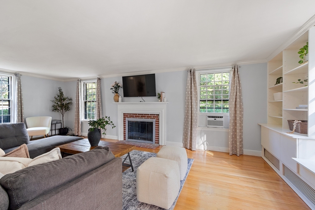 26 Wing Road Lynnfield, MA 01940 - Photo 18 of 39 a living room with furniture a fireplace and a flat screen tv