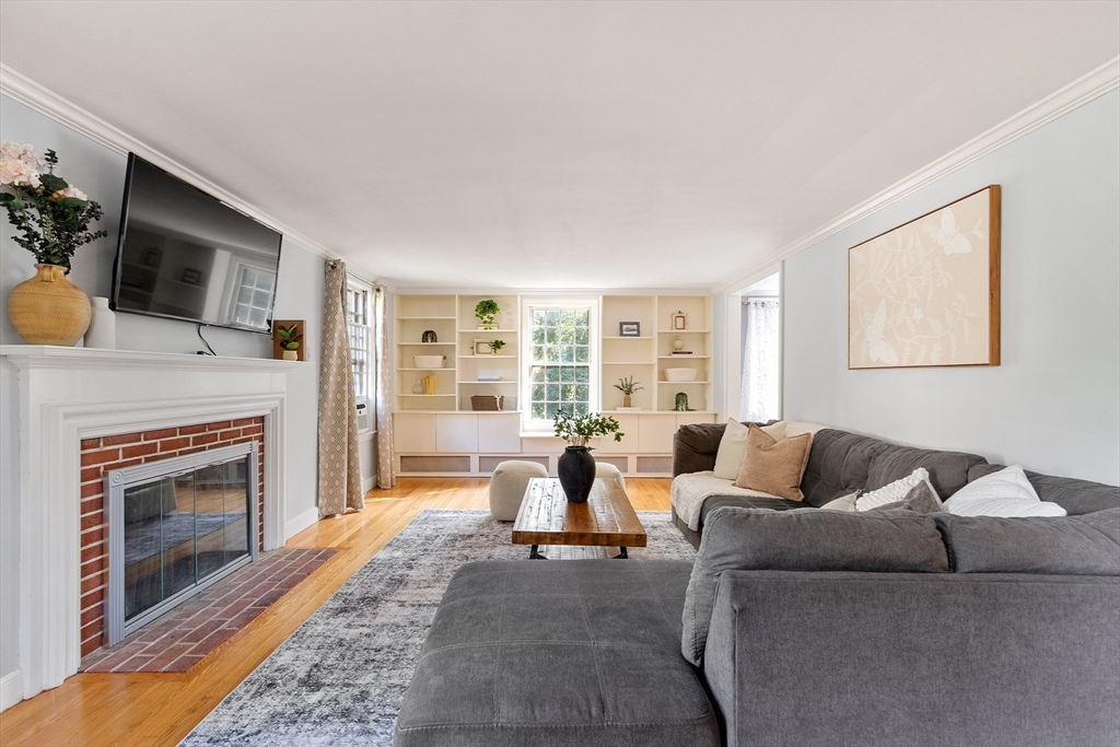 26 Wing Road Lynnfield, MA 01940 - Photo 19 of 39 a living room with furniture a fireplace and a flat screen tv