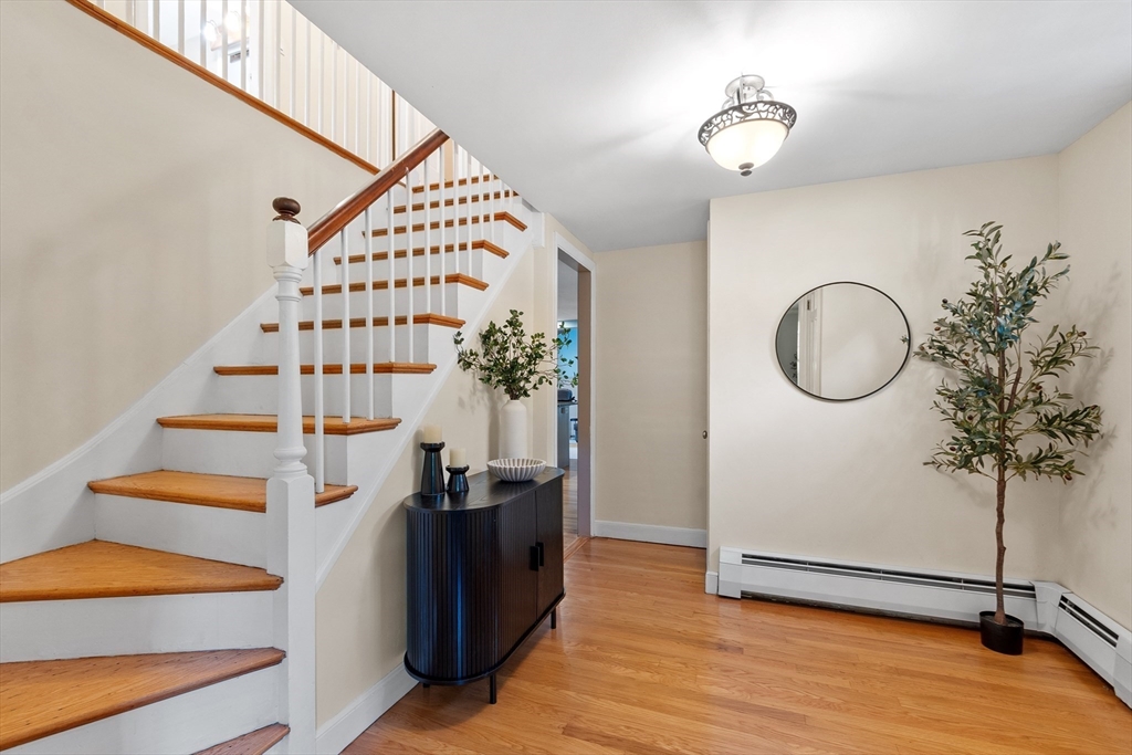26 Wing Road Lynnfield, MA 01940 - Photo 22 of 39 a view of a hallway with wooden floor and entryway