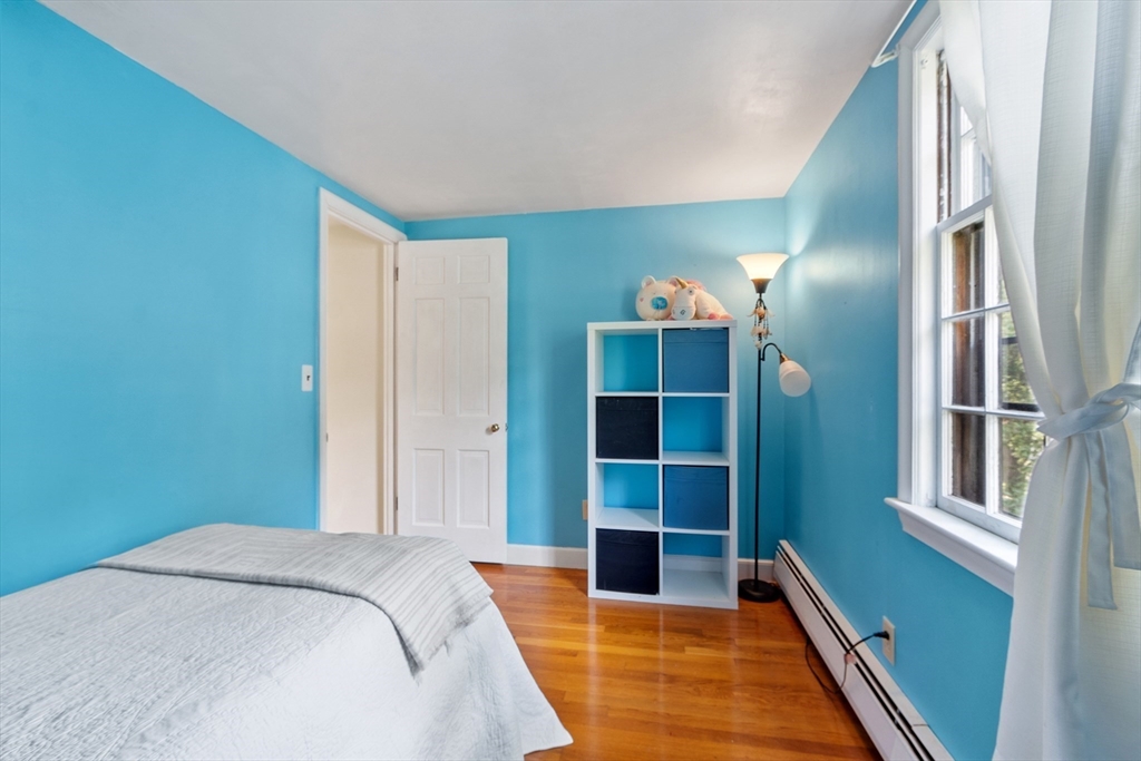 26 Wing Road Lynnfield, MA 01940 - Photo 24 of 39 a bed room with a bed and a potted plant