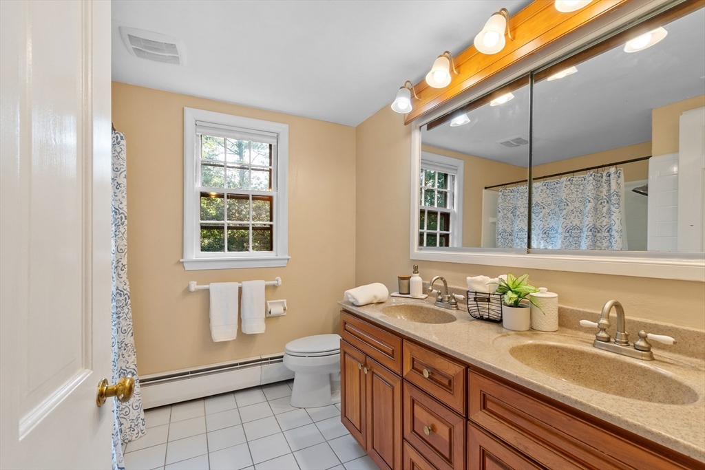 26 Wing Road Lynnfield, MA 01940 - Photo 25 of 39 a bathroom with a granite countertop sink mirror and a toilet