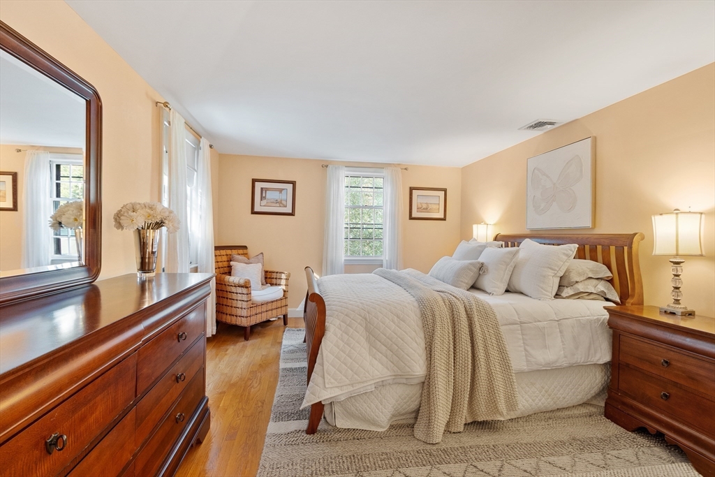 26 Wing Road Lynnfield, MA 01940 - Photo 30 of 39 a spacious bedroom with a bed and a large window