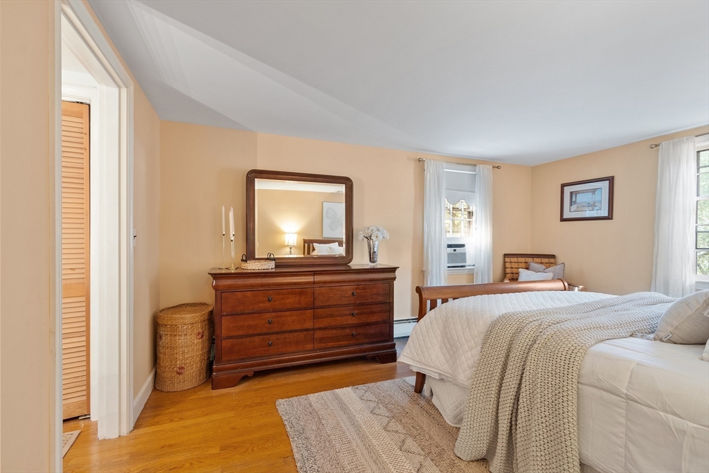 26 Wing Road Lynnfield, MA 01940 - Photo 31 of 39 a bedroom with a bed and a mirror on dresser