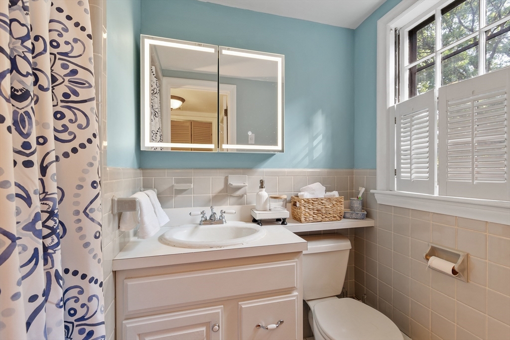 26 Wing Road Lynnfield, MA 01940 - Photo 32 of 39 a bathroom with a toilet sink and mirror