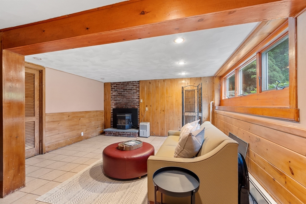 26 Wing Road Lynnfield, MA 01940 - Photo 34 of 39 a room with furniture a flat screen tv and floor to ceiling window