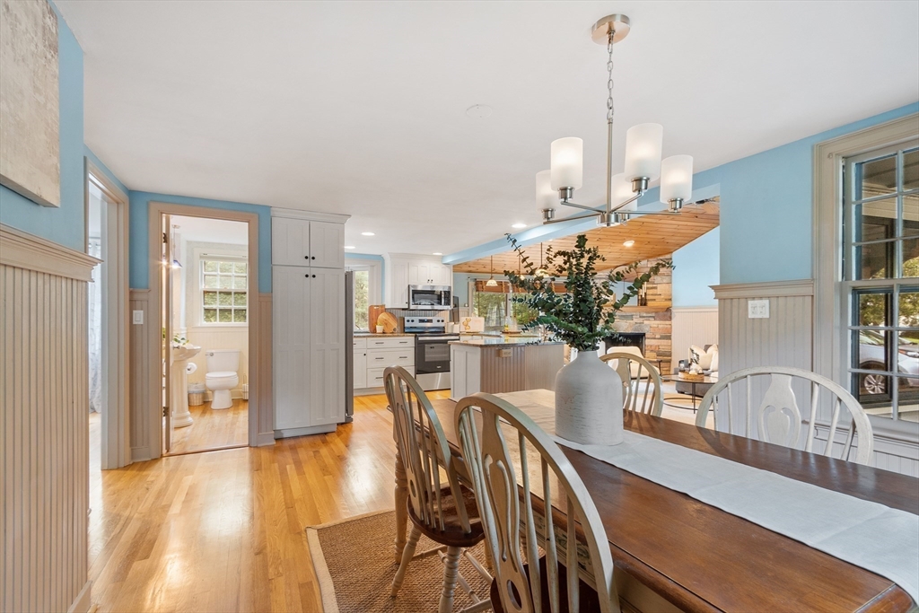 26 Wing Road Lynnfield, MA 01940 - Photo 10 of 39 a view of a dining room and livingroom with furniture wooden floor a chandelier