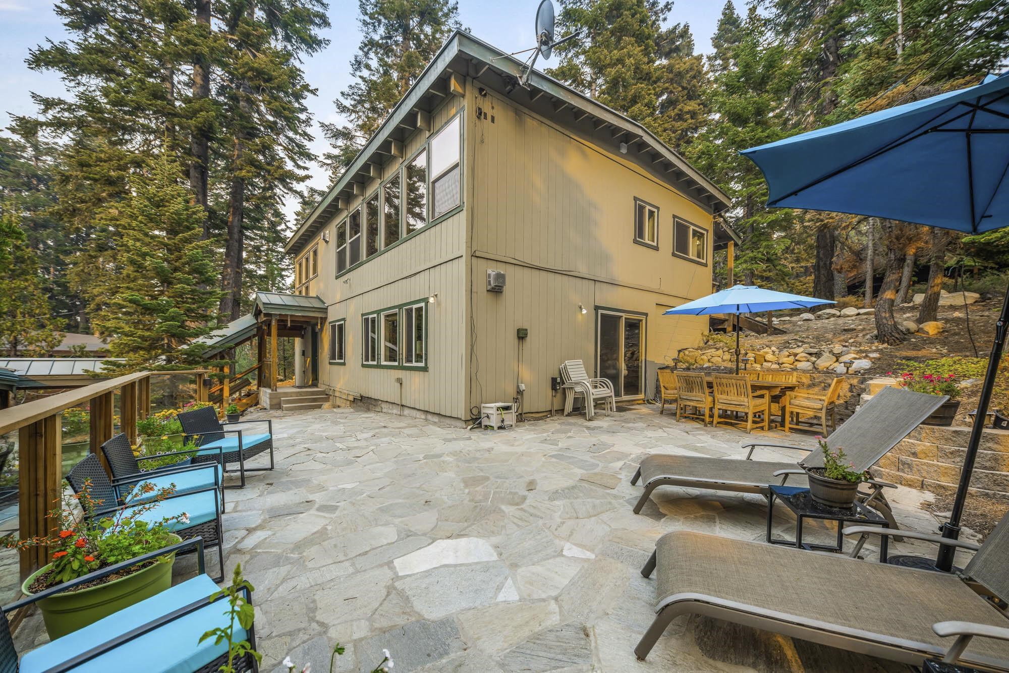 375 Ellis Road Homewood, CA 96141 - Photo 2 of 21 a view of a patio with a table and chairs under an umbrella
