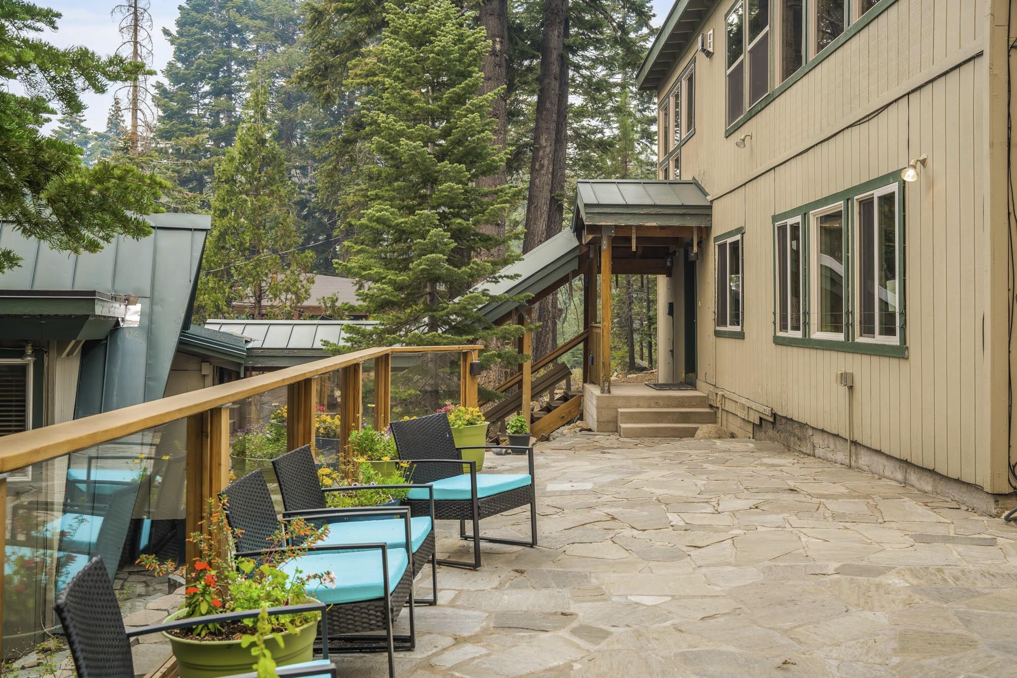 375 Ellis Road Homewood, CA 96141 - Photo 16 of 21 a view of wooden house with large windows and a table and chairs