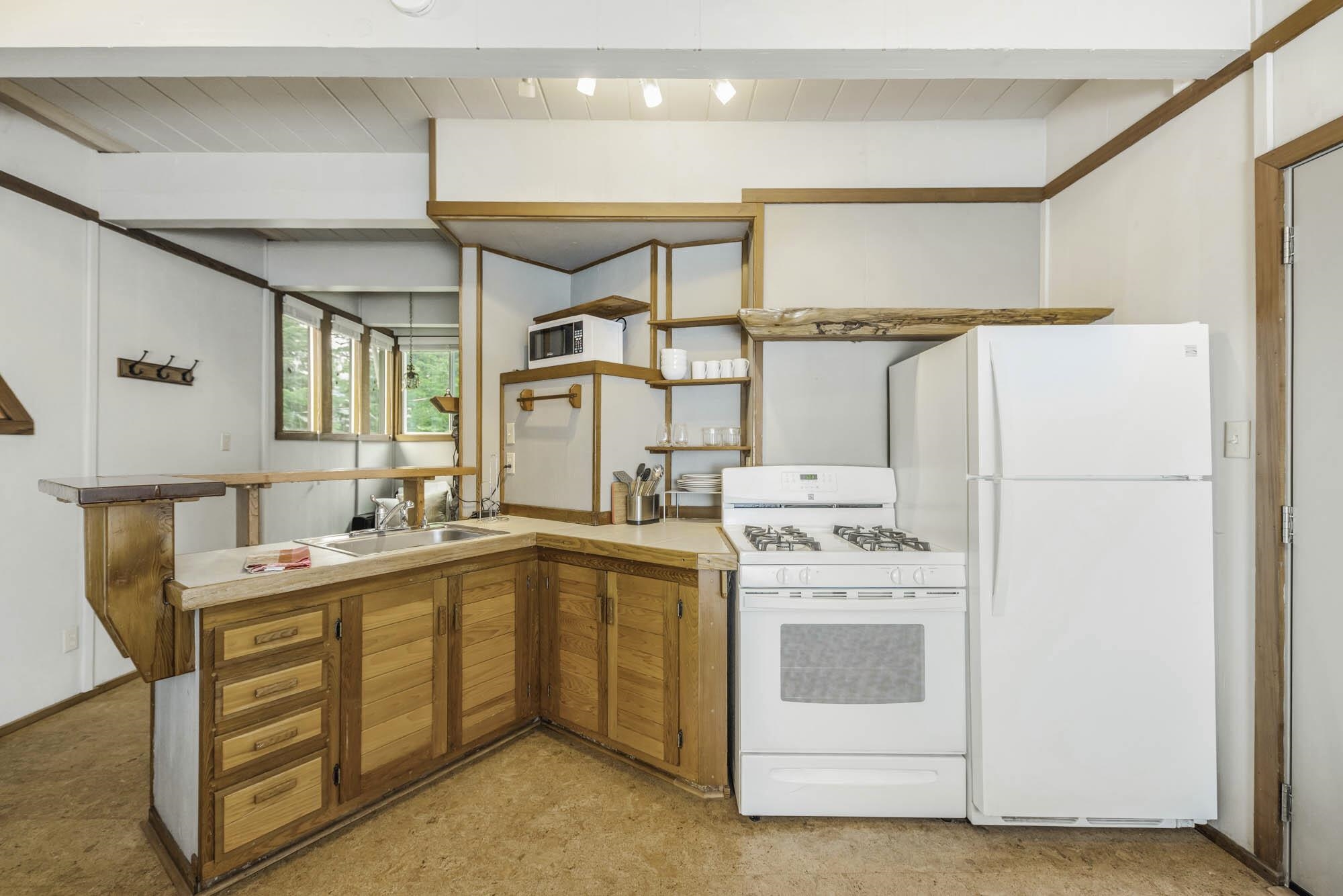 375 Ellis Road Homewood, CA 96141 - Photo 18 of 21 a kitchen with a sink a stove a refrigerator and a refrigerator