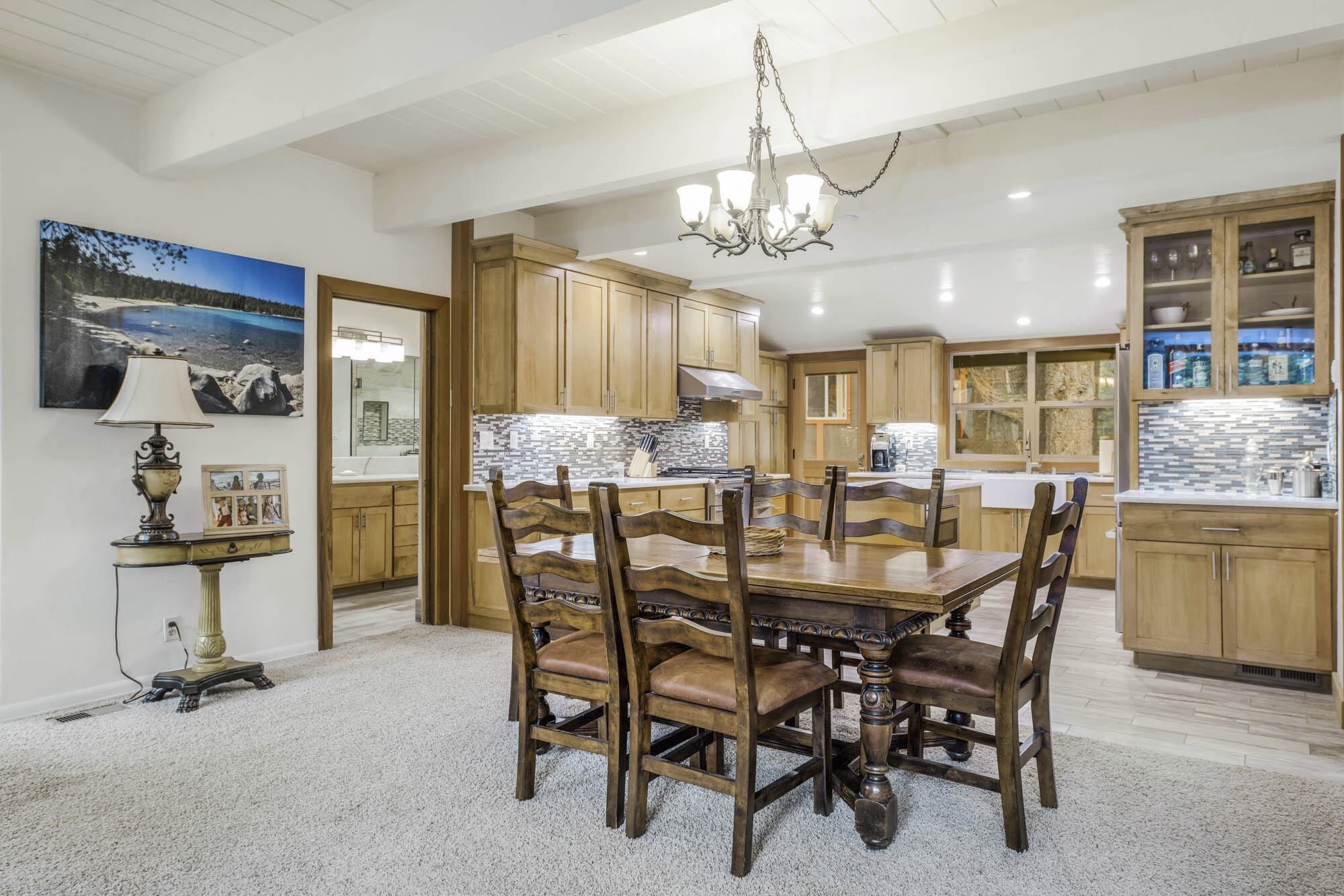 375 Ellis Road Homewood, CA 96141 - Photo 8 of 21 a dining room with furniture a chandelier and kitchen view