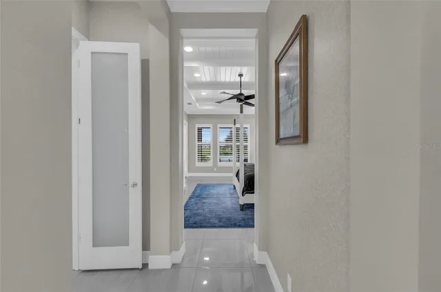 a bedroom with a bed and a lamp on dresser