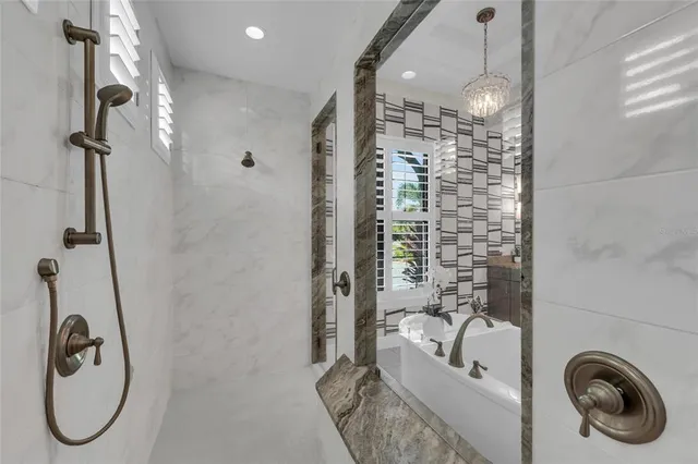 a living room with patio furniture and a floor to ceiling window