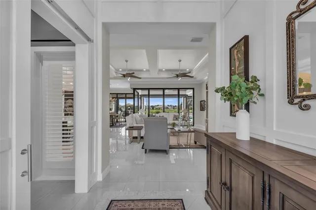 a living room with furniture a floor to ceiling window and a flat screen tv